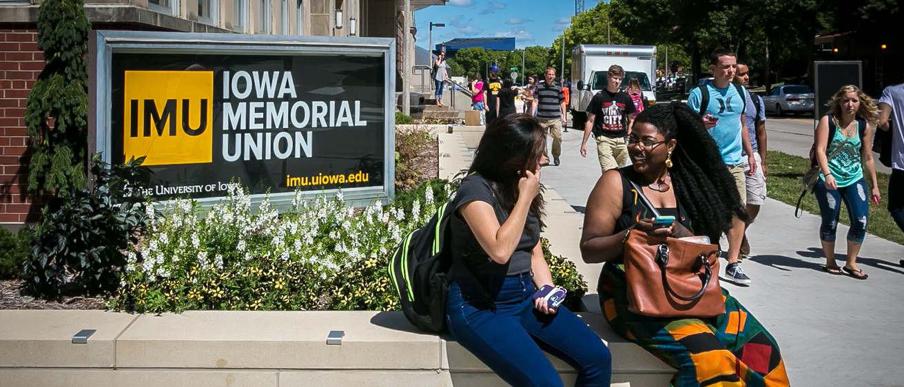 students sitting outside iowa memorial union